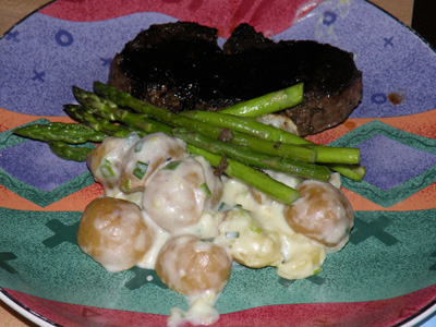 Beef tenderloin with fresh herb wet rub, gorgonzola potato hash, seared asparagus and balsamic reduction