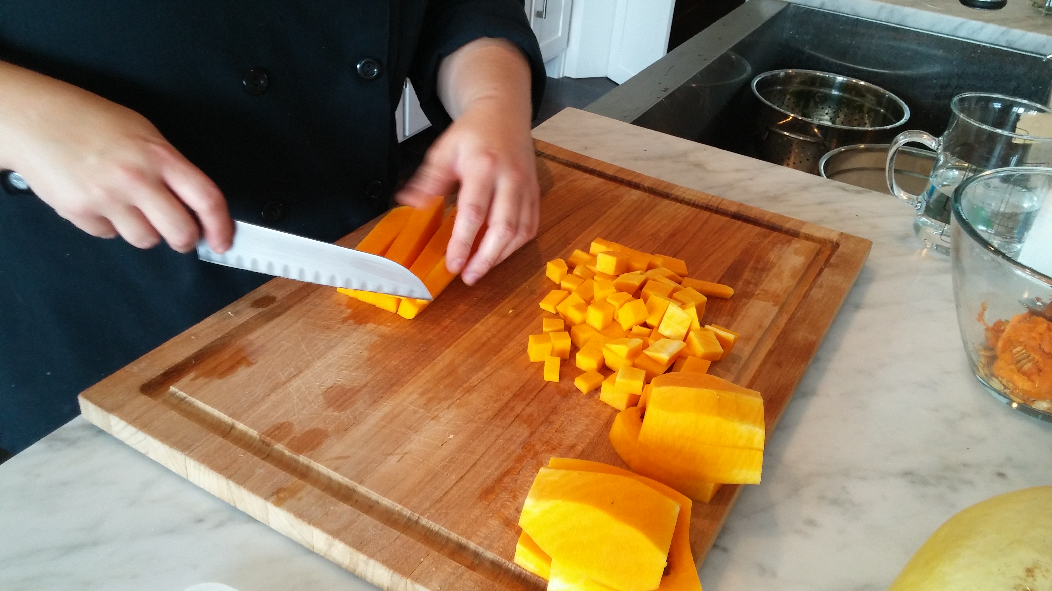 Dice butternut squash to roast as a side or for a salad. 